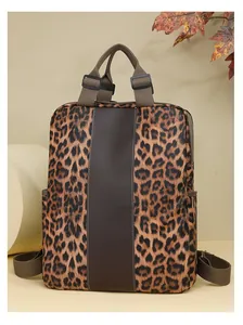 Detail of leopard print backpack with brown leather trim and adjustable shoulder straps