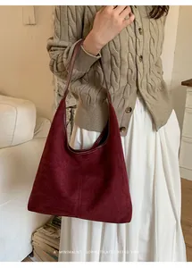 Close-up of a burgundy matte tote bag with shoulder straps for chic autumn outfits