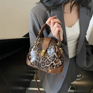 Modern leopard print shell handbag with adjustable strap and golden lock hardware