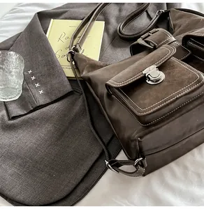 Detail of vintage brown leather crossbody bag with silver twist lock and adjustable strap