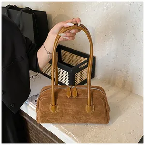 Brown suede baguette shoulder bag with contrast stitching and silver double zippers