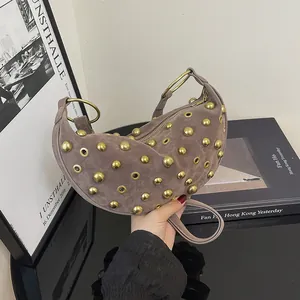 Taupe crescent handbag with gold rivets and ring handle in premium suede finish