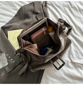 Interior view of vintage brown leather messenger bag with multiple storage compartments