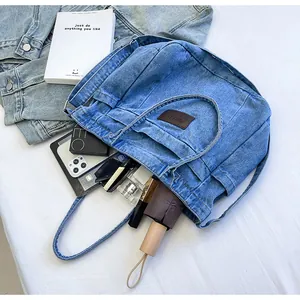 Spacious washed denim tote bag showing interior storage capacity with daily essentials