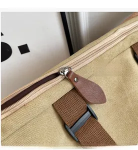 Macro view of smooth metal zipper closure with brown leather puller on canvas tote bag