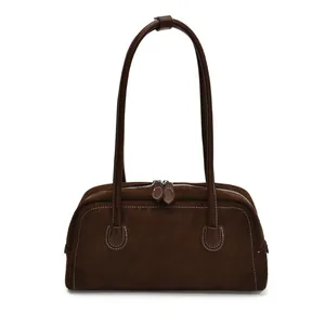 Deep brown suede baguette bag with long leather handles and white contrast stitching