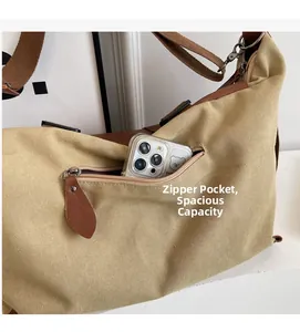 Detail view of khaki canvas tote featuring a functional front zipper pocket for phone storage