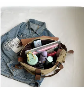 Top view of spacious khaki canvas tote interior with laptop and accessories