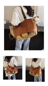 Detail of khaki canvas and brown leather tote bag with adjustable shoulder strap