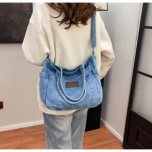 Detailed back view of a light blue washed denim tote bag styled for casual daily use