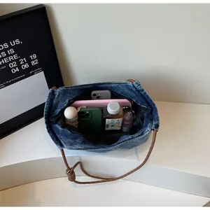 Interior detail of washed denim tote bag showing large capacity for daily essentials