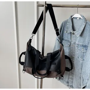 Detail of vintage canvas tote with leather straps and adjustable shoulder strap
