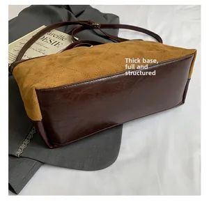 Detail showing the thick, structured bottom of this vintage two-tone large tote bag