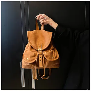 Retro brown faux suede backpack with vintage buckle details and front utility pockets