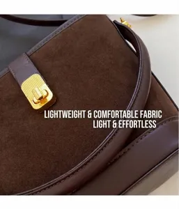 Detailed close-up of coffee brown suede leather拼接 with refined gold buckle and stitching