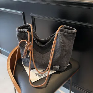 Dark grey denim tote bag with vibrant orange rope strap and stylish braided detail