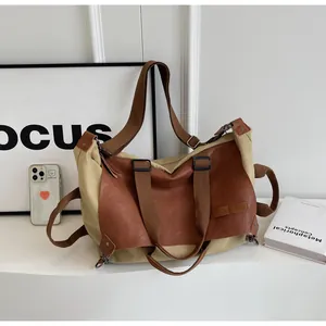 Detail of vintage tote bag showing canvas leather texture and adjustable shoulder strap