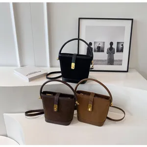 Three frosted leather bucket bags in black, dark coffee and camel colors with gold hardware