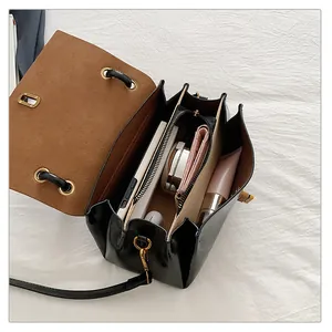 Macro view of organ-style inner structure of black crossbody bag with multiple compartments