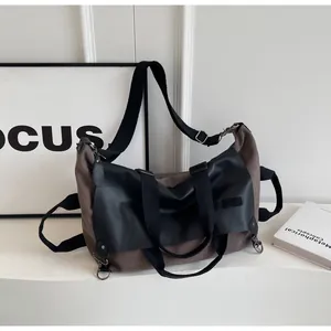 Close-up of multi-functional tote bag showing canvas leather stitching and metal D-rings