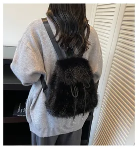 Close-up of black faux fur backpack featuring a drawstring closure and soft texture