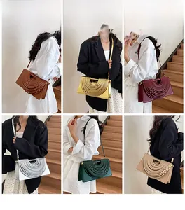 Detailed view of woven structured small square handbags in six vibrant colors on models