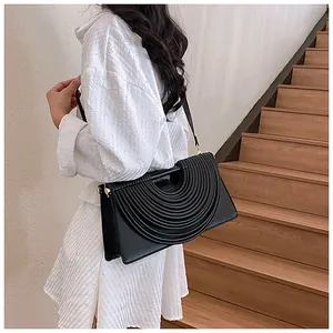 Detailed close-up of a black pleated leather handbag with elegant semi-circular textures