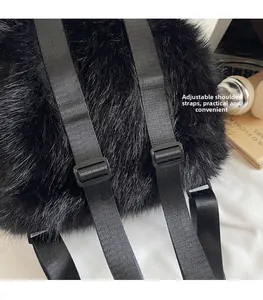 Detail view of adjustable black plush backpack straps with durable plastic buckles