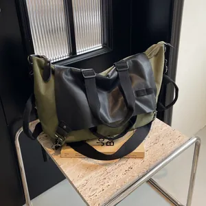 Retro army green canvas and black leather tote bag with adjustable shoulder strap