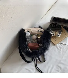 Detail view of the plush black bucket bag showing spacious interior with daily essentials