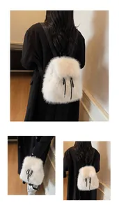 Detail of white faux fur backpack featuring soft plush texture and black drawstrings