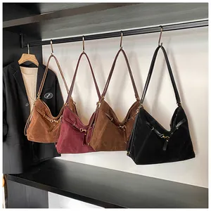 Detail view of large suede hobo bags in four colors with metal buckles for women