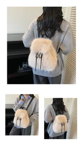 Detail view of plush faux fur backpack in light beige with black strap accents