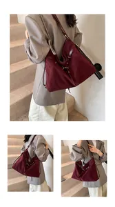 Detail view showing deep burgundy suede tote bag with gold hardware on a model