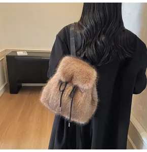 Detail of khaki faux fur drawstring backpack with black straps shown on a model