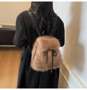 Detail of soft brown faux fur backpack with black drawstring and nylon straps