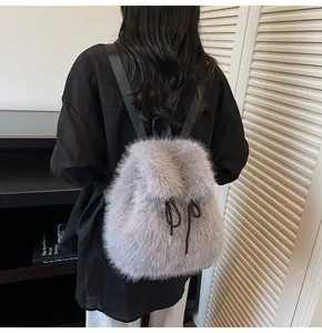Detail of plush faux fur backpack in grey-purple with adjustable black shoulder straps