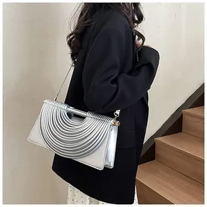 Side view of a silver pleated shoulder bag featuring modern industrial wave textures