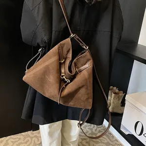 Deep brown suede tote bag with large capacity and adjustable strap shown on model