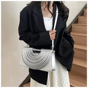 Close-up of the silver woven texture and metallic finish on this stylish crossbody bag