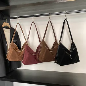 Large capacity vintage suede tote bags in four colors hanging on a minimal display