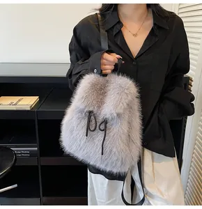Detail of grey fluffy faux fur backpack with black drawstring closure and nylon straps