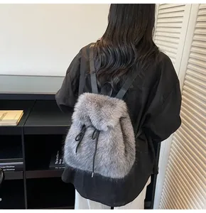 Detail of grey faux fur backpack showing fluffy texture and black drawstring closure