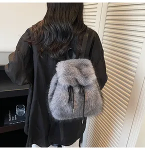 Detail view of the soft grey faux fur backpack showing fluffy texture and black straps