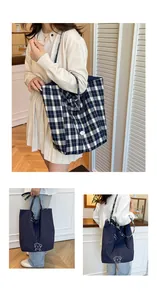 Detail of reversible tote bag showing blue checkered pattern and dog print canvas texture