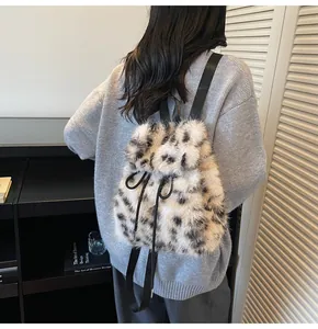 Detail of plush leopard print backpack with drawstring closure and soft faux fur texture