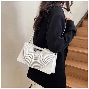 Detail view of a white woven shoulder bag with unique fan-shaped pleated texture