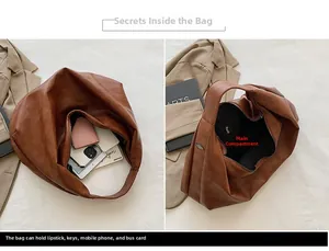 Macro detail of the spacious main pocket in a brown textured leather tote bag