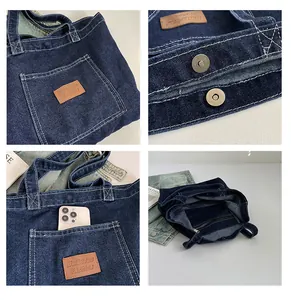 Detail view of denim tote bag with magnetic closure, leather tag, and inner zipper pocket