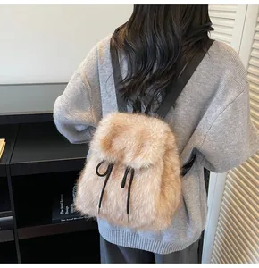 Detailed view of the soft faux fur texture and drawstring on a beige plush backpack